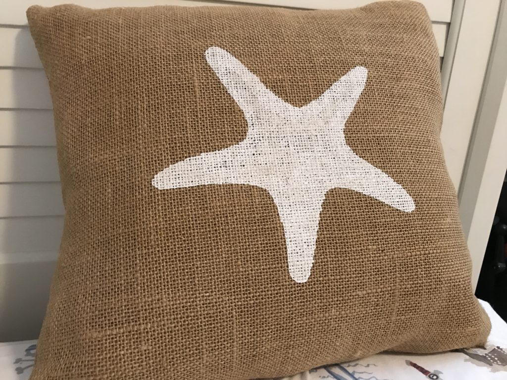 Burlap covered sea star pillow being reinvented for Christmas.