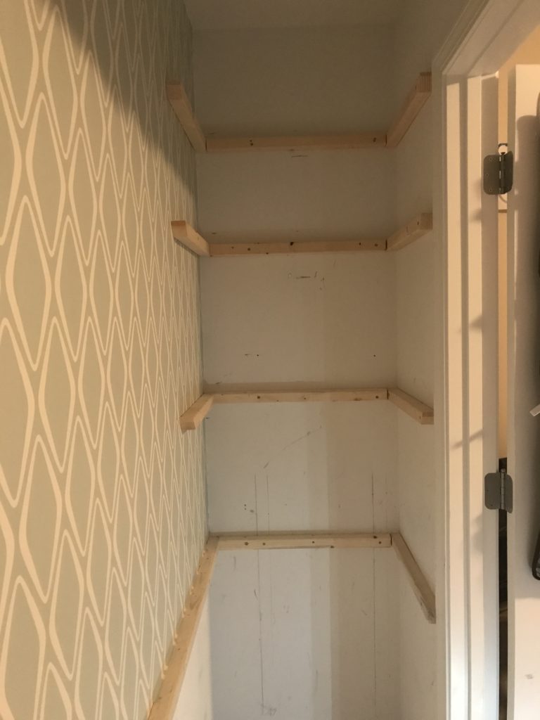 The is the right side of the closet with unpainted supports in place for the desktop and 3 side shelves. Part of the closet office makeover.