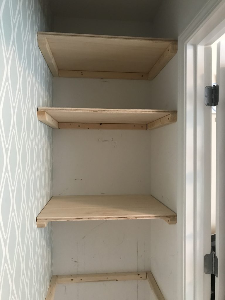 Pre-paint side shelving for the closet office makeover.