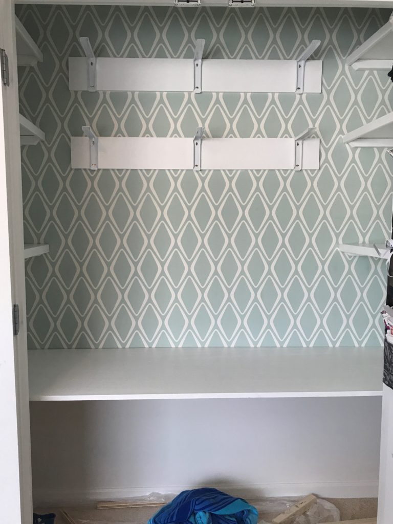 Here is the painted and installed desktop and side shelving for the closet office makeover. And the beginnings of the middle shelves.